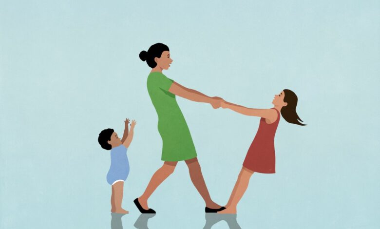 Happy, carefree mother playing with daughter and baby son