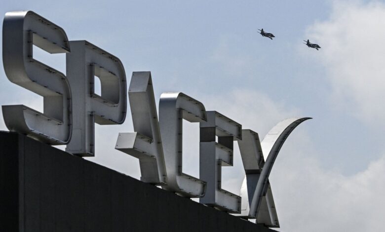 US billionaire businessman and pilot Jared Isaacman flies in formation aboard a fighter jet over the SpaceX sign, close to the Starship spacecraft, before his third test flight from Starbase in Boca Chica, Texas, on March 13, 2024. Elon Musk's SpaceX announced it was eyeing March 14 as the earliest date for the next test launch of its giant Starship rocket, with which it hopes to one day colonize Mars. Two previous attempts have ended in spectacular explosions, though the company has adopted a rapid trial-and-error approach in order to accelerate development. (Photo by CHANDAN KHANNA/AFP via Getty Images)