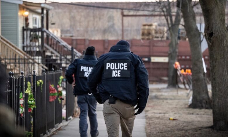US Immigration and Customs Enforcement (ICE) agents walk down a street during a multi-agency targeted enforcement operation in Chicago, Illinois, US, on Sunday, Jan. 26, 2025.